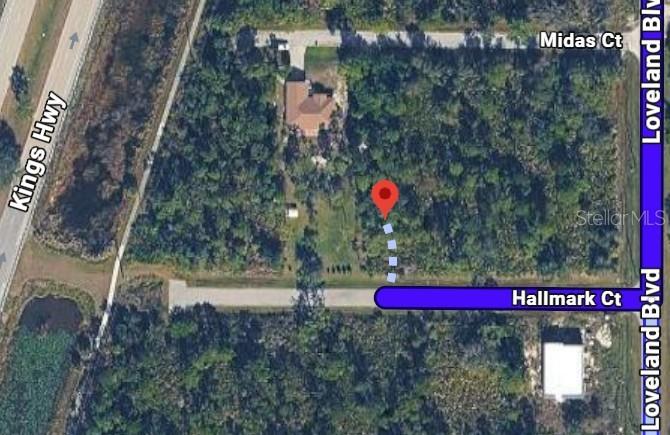 This is an aerial map showing a vacant lot with a red location pin — 23498 HALLMARK COURT, PORT CHARLOTTE, FL