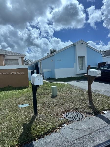A light blue one-story house features two mailboxes in the front yard — 14952 SW 75th Ter, Miami FL 33193, MIAMI, FL