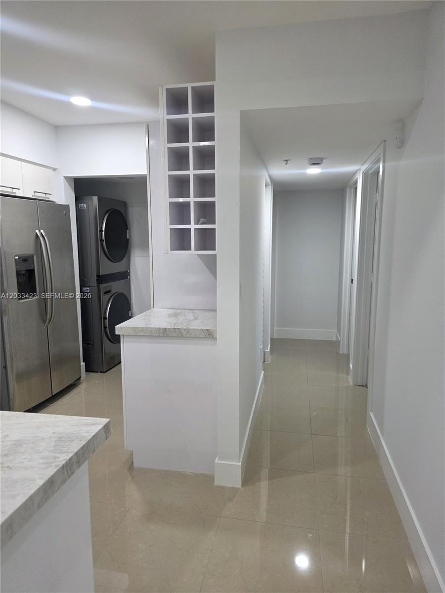A dining area with a wooden table and four chairs sits next to a kitchen counter — 2600 S University Dr # 229, Davie FL 33328, DAVIE, FL