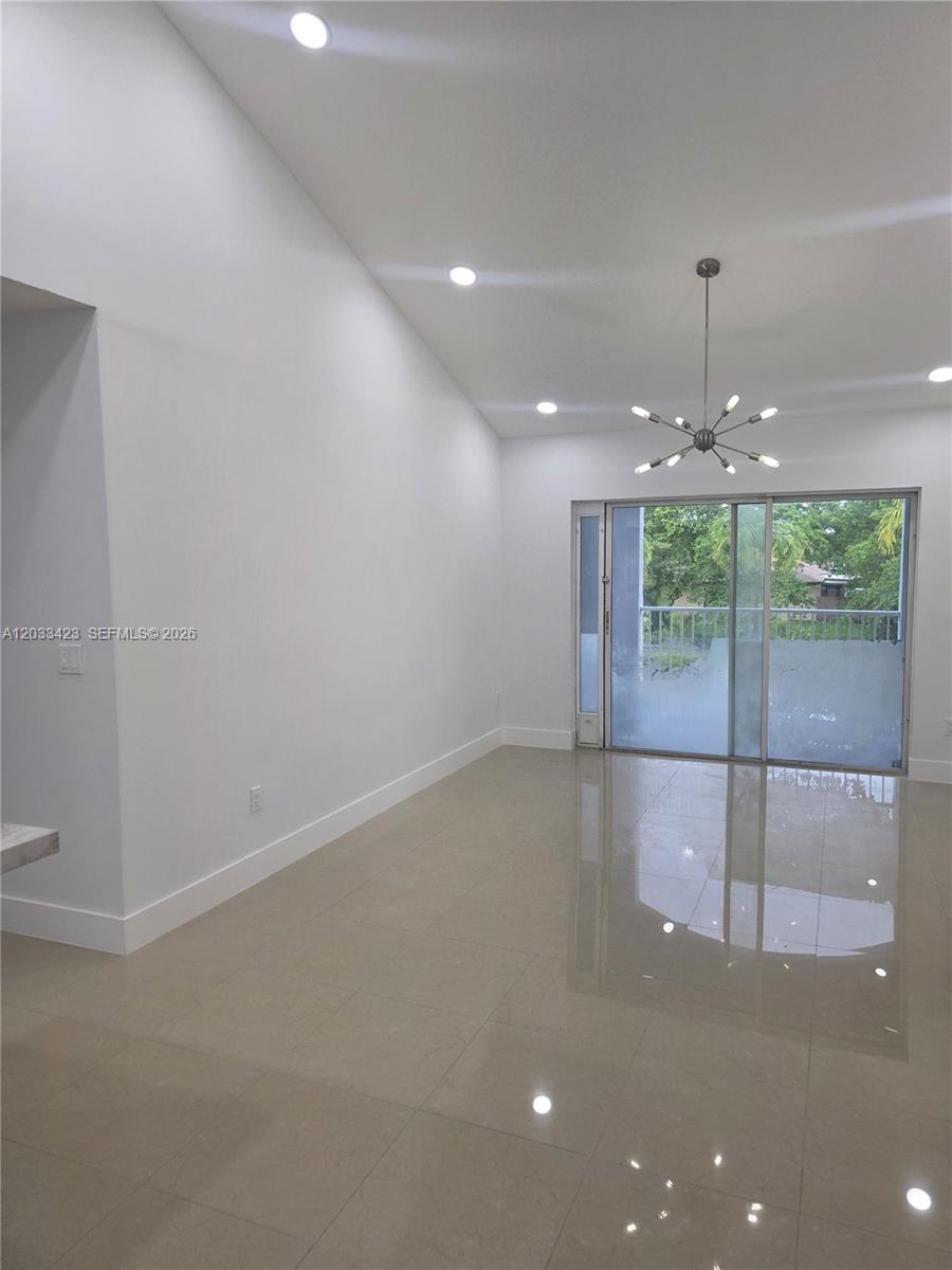 A tall white pantry cabinet stands next to a base cabinet with a stone countertop — 2600 S University Dr # 229, Davie FL 33328, DAVIE, FL