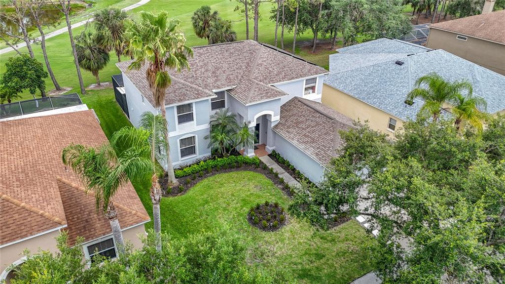 An aerial view shows a two-story house with a shingled roof and a front lawn — 18109 KARA COURT, TAMPA, FL