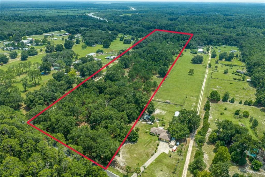 An aerial view shows a rectangular plot of land densely covered with trees and vegetation — TBD SE 95TH ST RD, OCKLAWAHA, FL