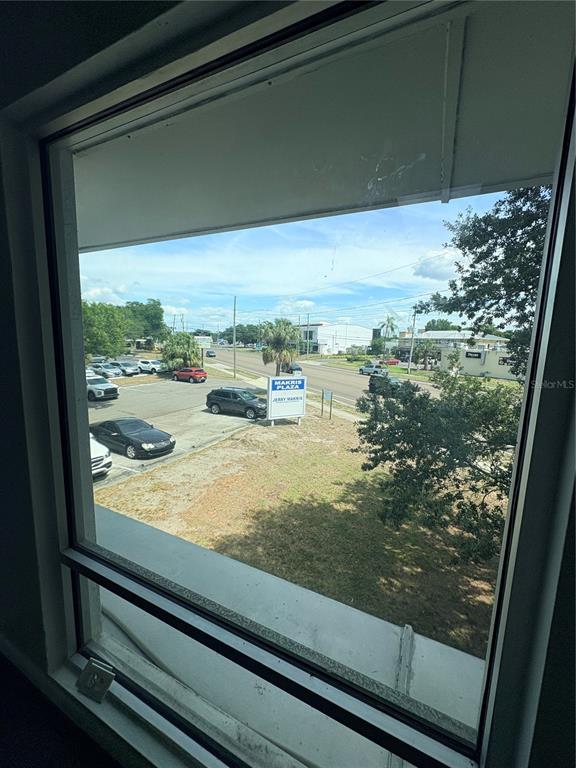 A view of a parking lot and a street sign from inside a building window — 2110 DREW STREET (2nd floor), CLEARWATER, FL