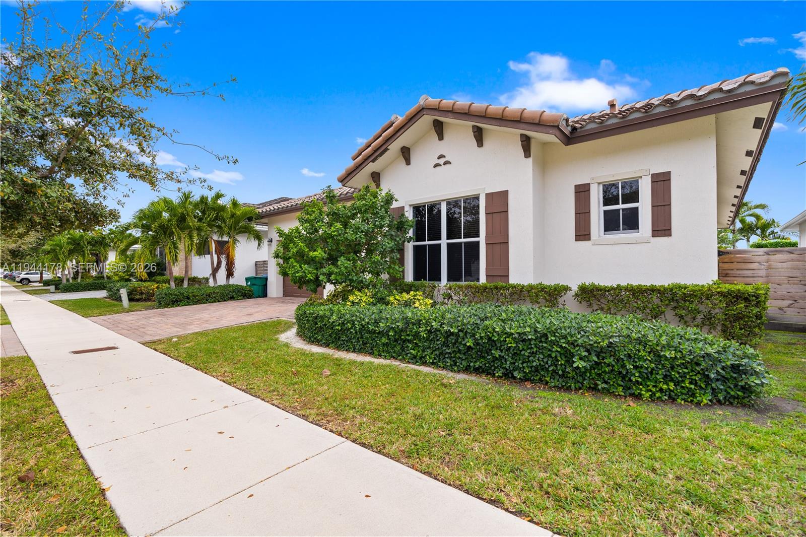 A single-story house with a white stucco exterior, brown shutters, and a tiled roof — 15102 SW 177th Ter, Miami FL 33187, MIAMI, FL