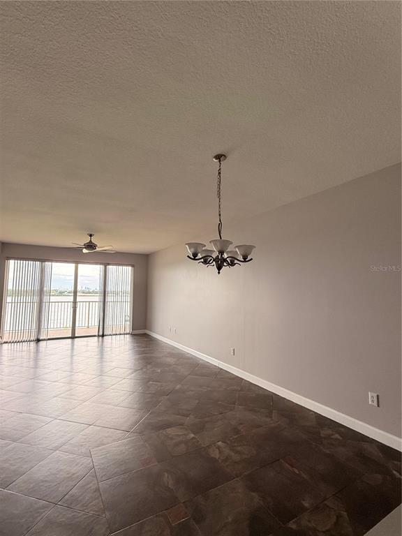 A hallway with tiled floors leads toward a living area with a view of water — 6312 BUFORD STREET UNIT 704, ORLANDO, FL