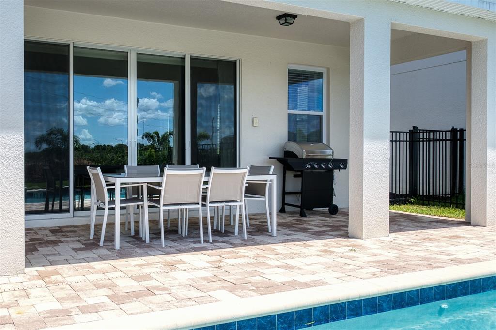 A two-story house exterior features a swimming pool, spa, and patio in the backyard — 7763 WESTLAND DRIVE, KISSIMMEE, FL