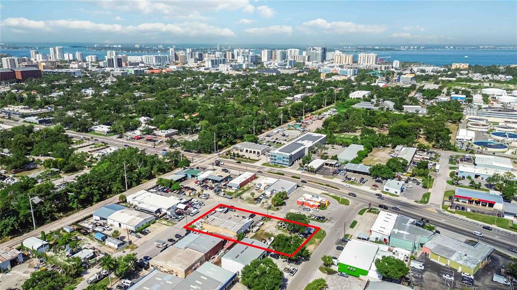 An aerial view shows a commercial property outlined in red within a suburban city landscape — 2011 CORNELL STREET, SARASOTA, FL