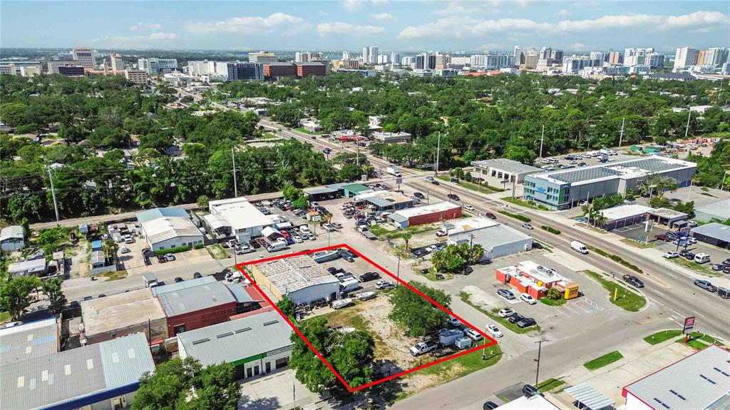 An aerial view shows a commercial property outlined in red within a suburban landscape — 2011 CORNELL STREET, SARASOTA, FL