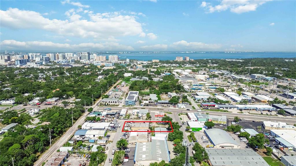 This aerial view shows a commercial property outlined in red within a suburban landscape — 2011 CORNELL STREET, SARASOTA, FL