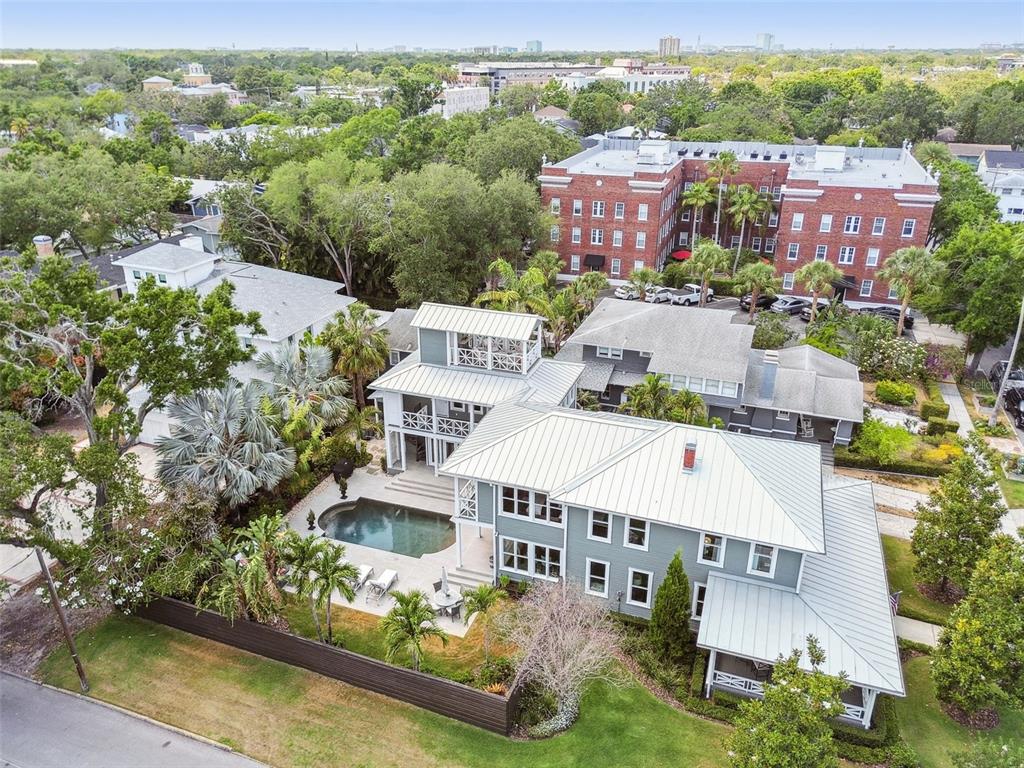 An aerial view shows a multi-story gray house with a metal roof and swimming pool — 1411 S ALBANY AVENUE, TAMPA, FL