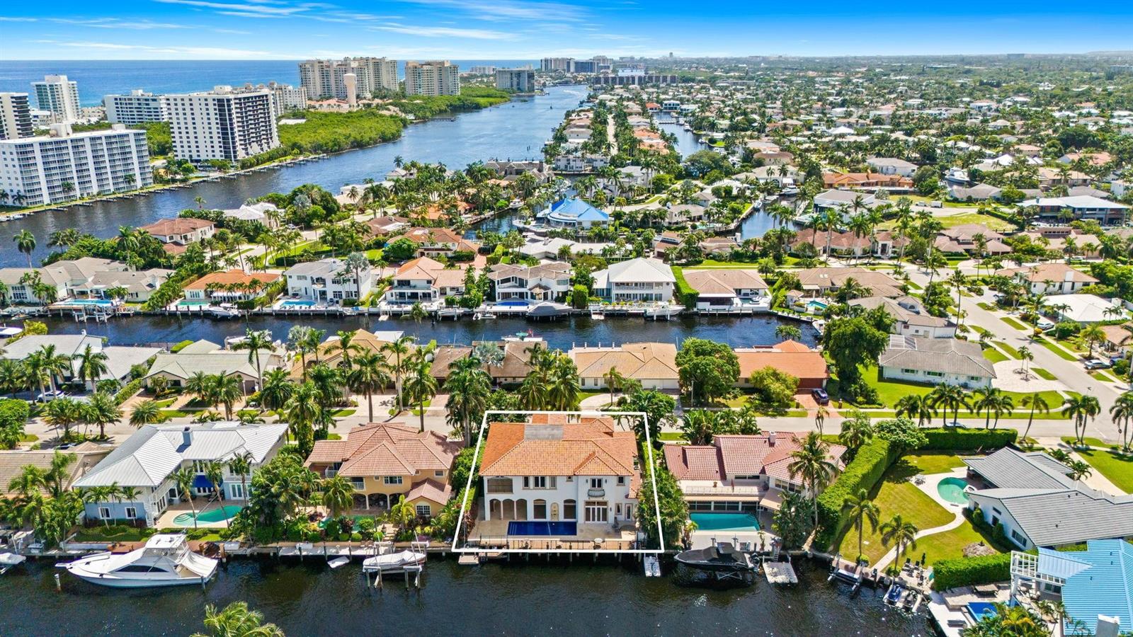 An aerial view of a waterfront house with a pool and boat dock in Florida — 861 Nafa Drive, Boca Raton FL 33487, BOCA RATON, FL