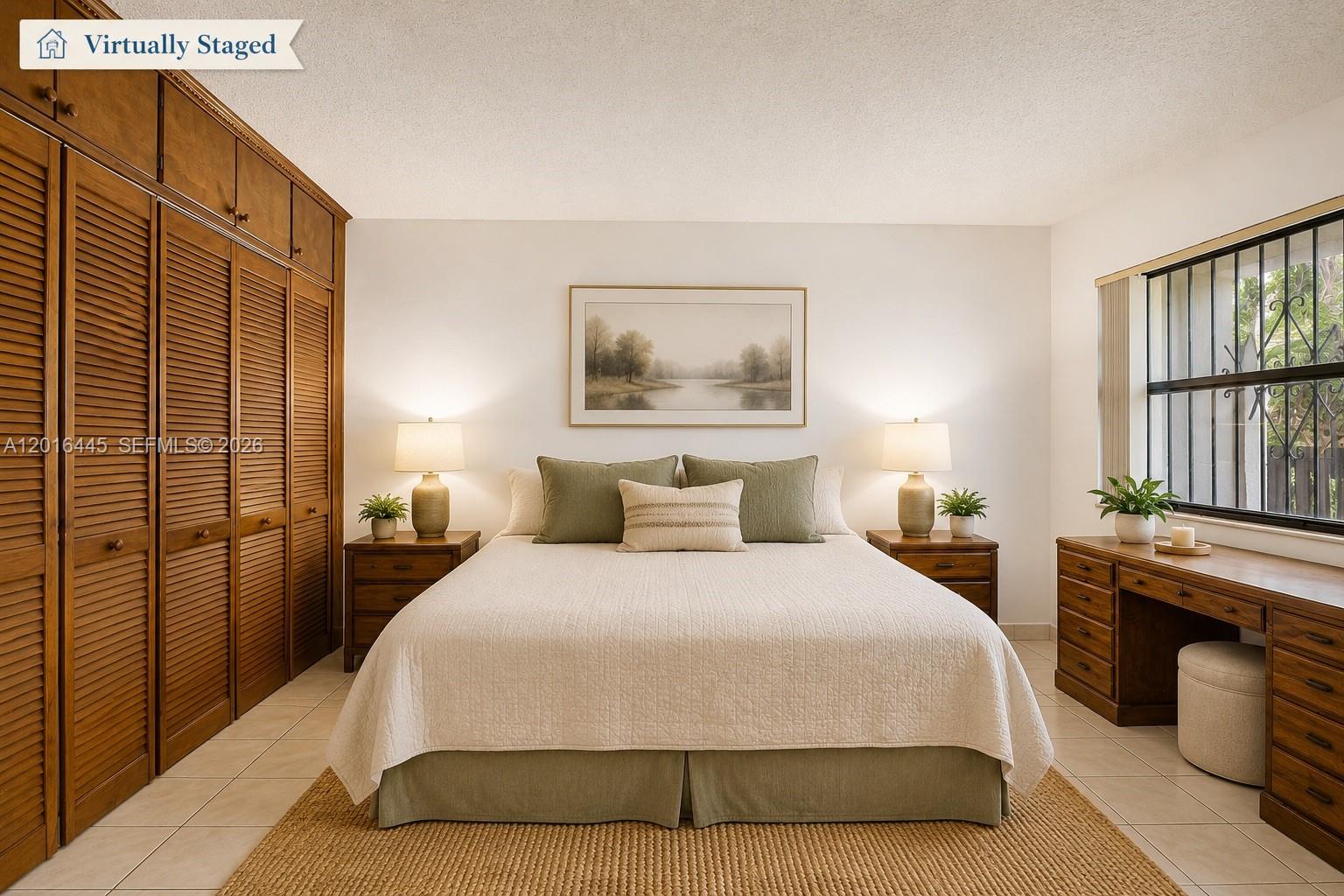 This bedroom features a large wooden closet, a bed with green accents, and a desk — 425 W Park Dr # 10, Miami FL 33172, MIAMI, FL