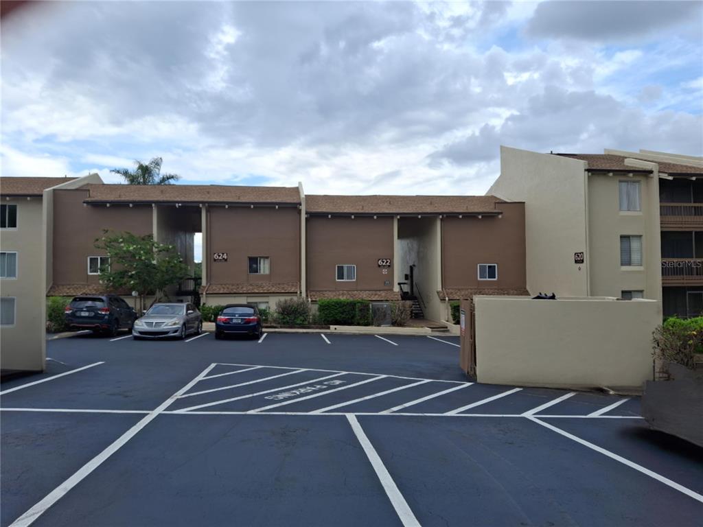 A multi-story apartment building exterior with a parking lot in the foreground — 622 ORANGE DRIVE UNIT 232, ALTAMONTE SPRINGS, FL