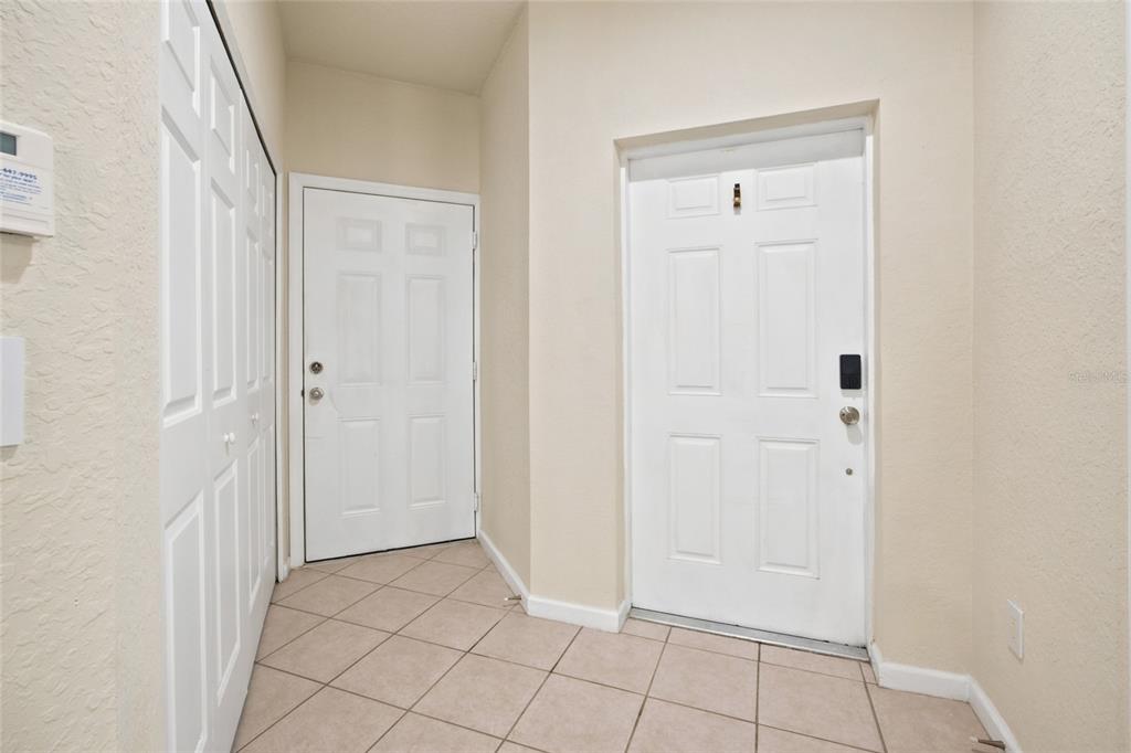 An entryway features tiled flooring, two white doors, and a set of white closet doors — 4550 SW 52ND CIRCLE UNIT 109, OCALA, FL