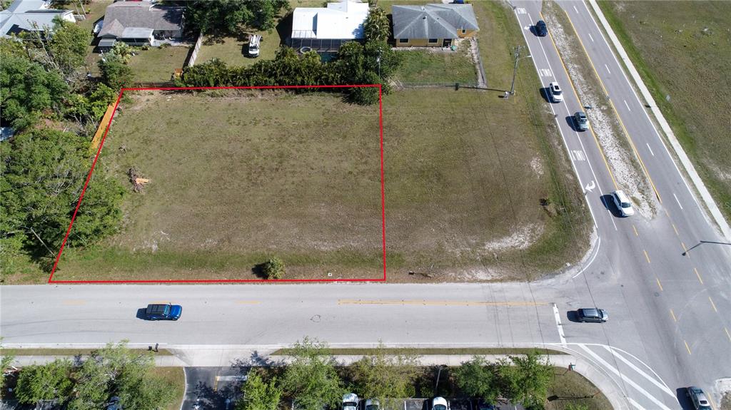 An aerial view shows a vacant rectangular lot outlined in red next to a road — 758 SW 4TH STREET, CAPE CORAL, FL