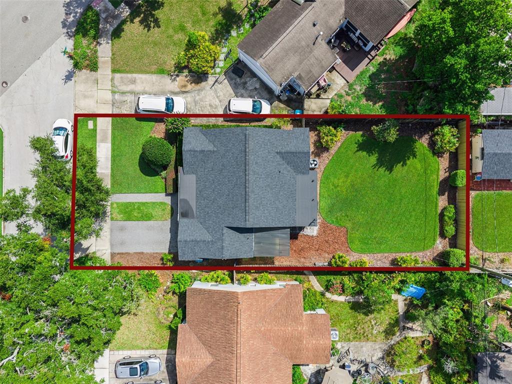 An aerial view shows a house with a gray roof, a driveway, and a backyard — 3365 PELHAM ROAD, ORLANDO, FL