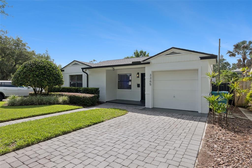 A single-story house with a white exterior, a paved driveway, and a one-car garage — 3365 PELHAM ROAD, ORLANDO, FL