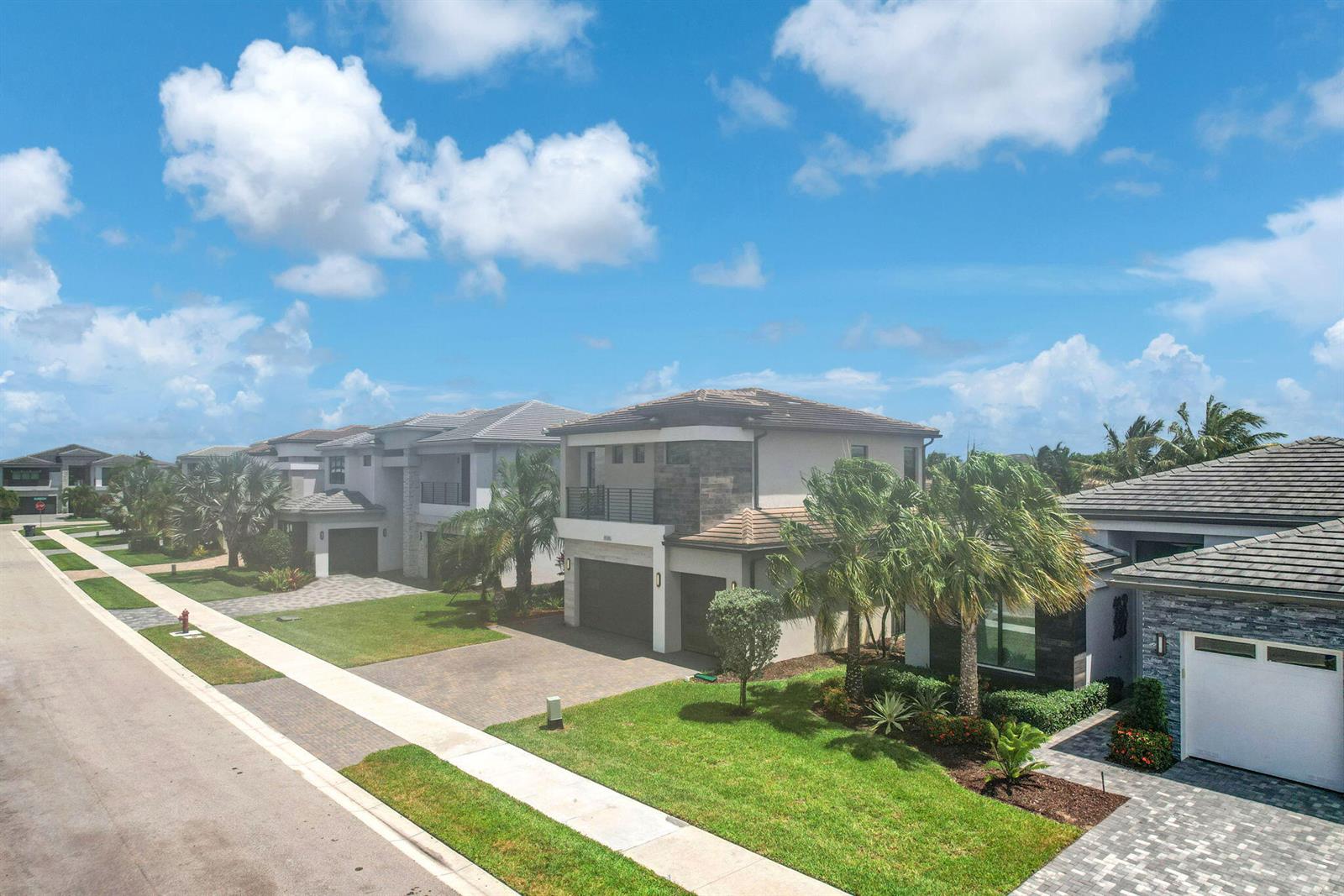 An aerial view shows a suburban street with modern two-story houses and manicured lawns — 8586 Dream Falls Street, Boca Raton FL 33496, BOCA RATON, FL
