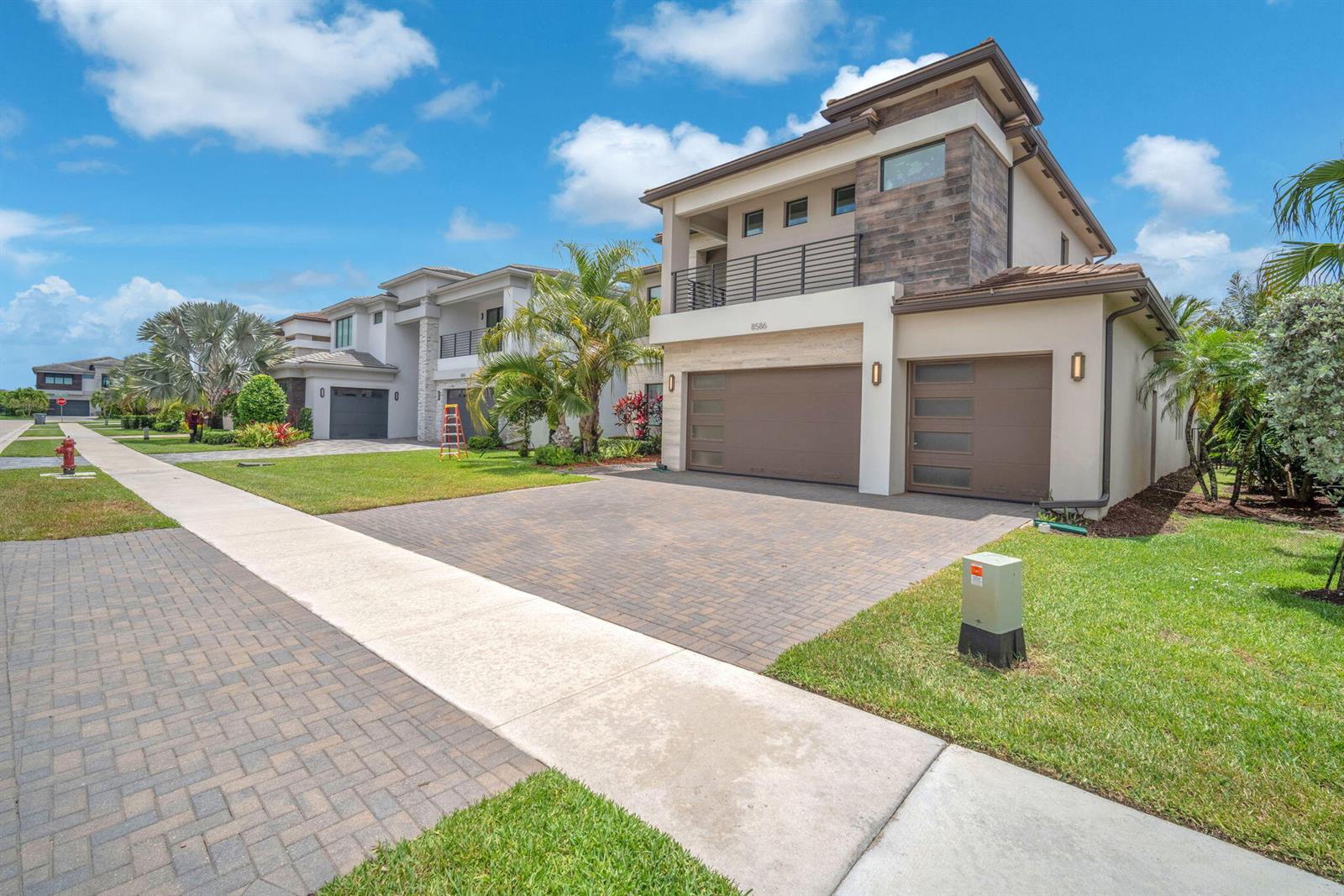 A modern two-story house with a brick driveway and a three-car garage — 8586 Dream Falls Street, Boca Raton FL 33496, BOCA RATON, FL