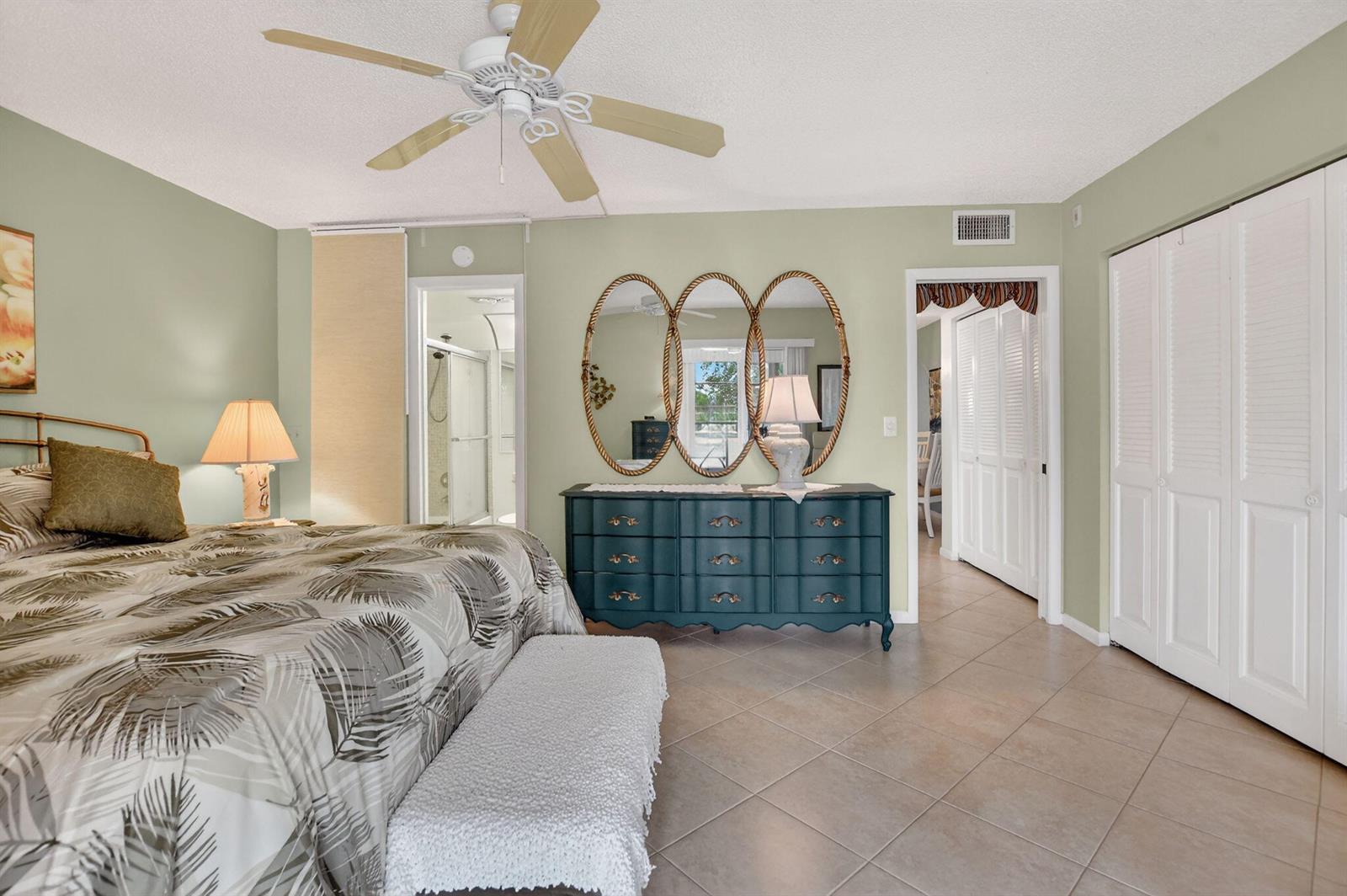 An exterior view of a building hallway featuring a white door and large windows — 2010 N Farnham N, Deerfield Beach FL 33442, DEERFIELD BEACH, FL