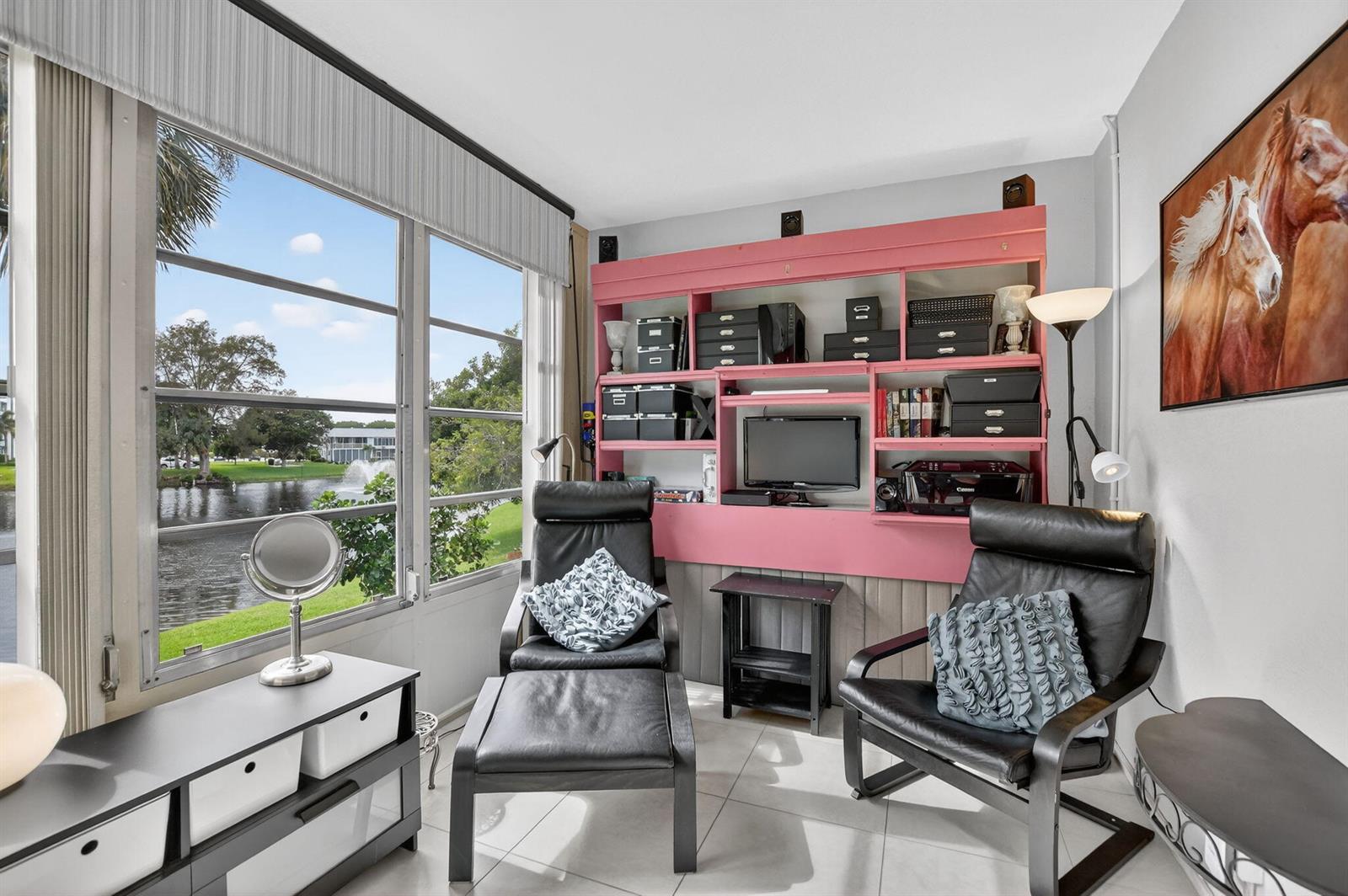 A bedroom with light green walls, tile floors, a ceiling fan, and a sliding glass door — 2010 N Farnham N, Deerfield Beach FL 33442, DEERFIELD BEACH, FL