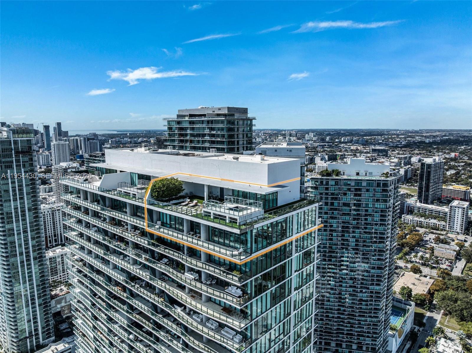 An aerial view of a high-rise building featuring a large outdoor terrace with landscaping — 3131 NE 7th Ave, Miami FL 33137, MIAMI, FL