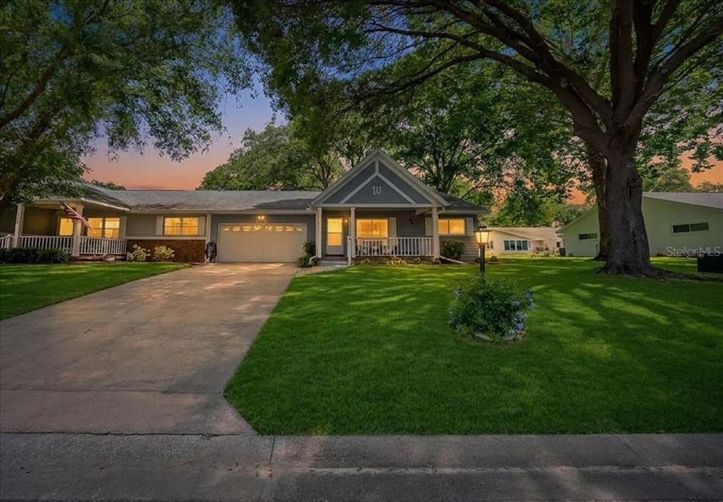 A single-story house with a gray exterior, a front porch, and a concrete driveway — 8889 SW 96TH STREET UNIT F, OCALA, FL