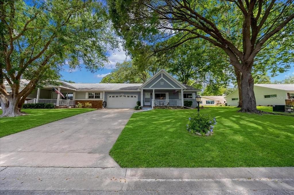 A single-story house with a gray exterior, a two-car garage, and a front porch — 8889 SW 96TH STREET UNIT F, OCALA, FL