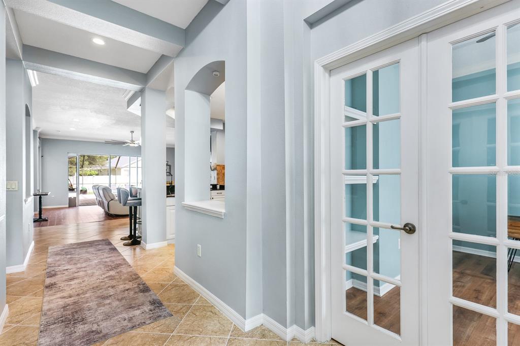A bright entryway features a white front door, tile flooring, and a recessed wall niche — 12114 CREEK EDGE DRIVE, RIVERVIEW, FL