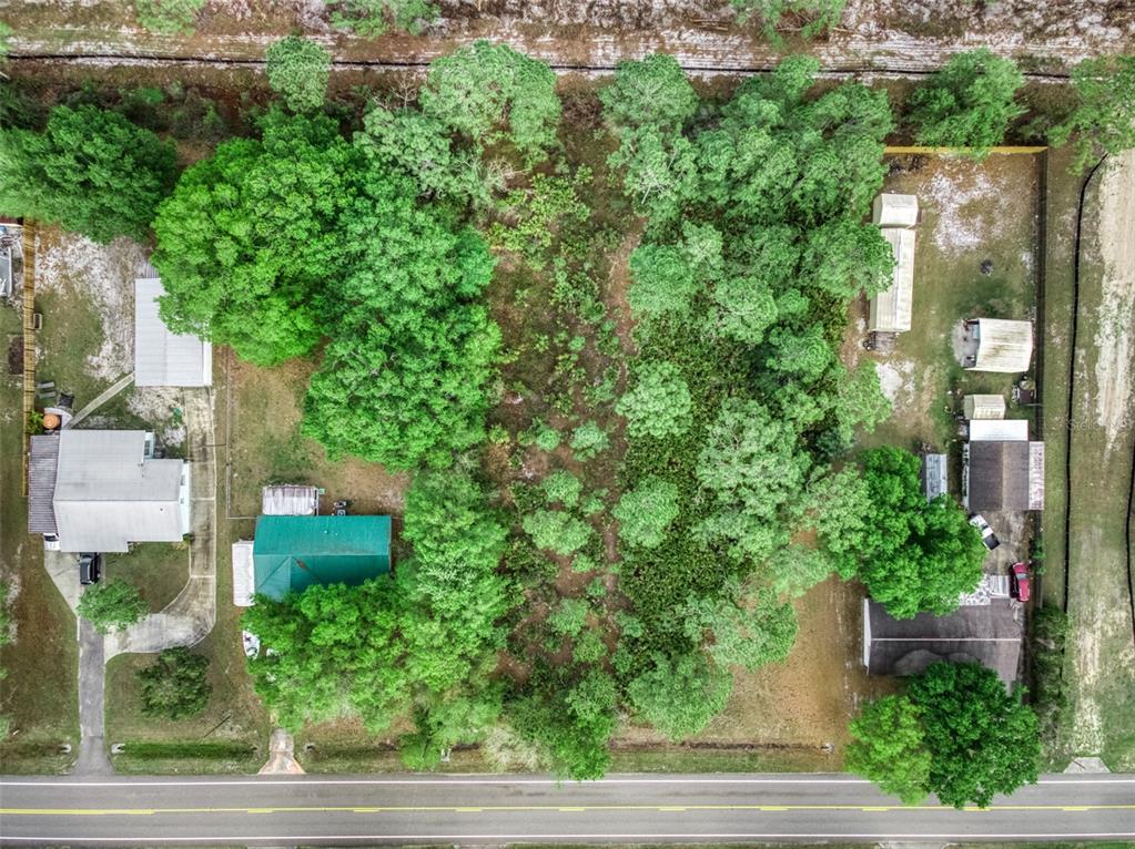 An aerial view shows two houses on a wooded lot bordering a paved road — 4814 LAKEWOOD ROAD, SEBRING, FL