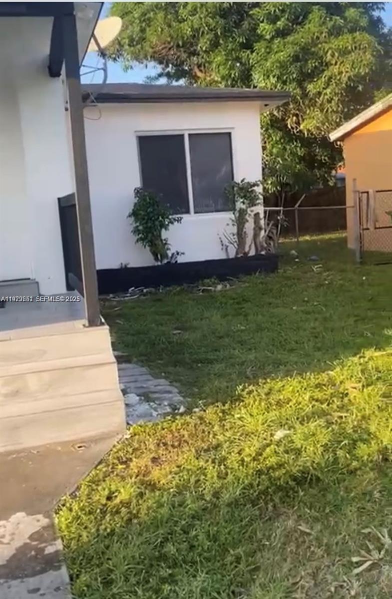 A white house exterior features a small front yard, a window, and concrete steps — 3085 NW 51st St, Miami FL 33142, MIAMI, FL