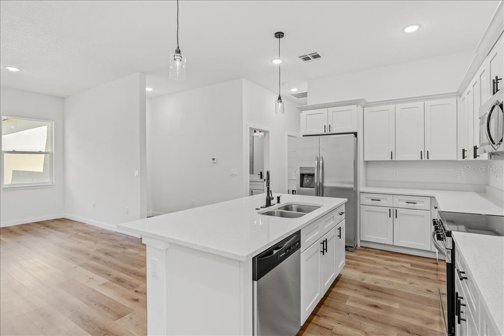 This is a rendering of an open-concept living room and kitchen with light wood flooring — 10611 N UMBER TERRACE, CITRUS SPRINGS, FL