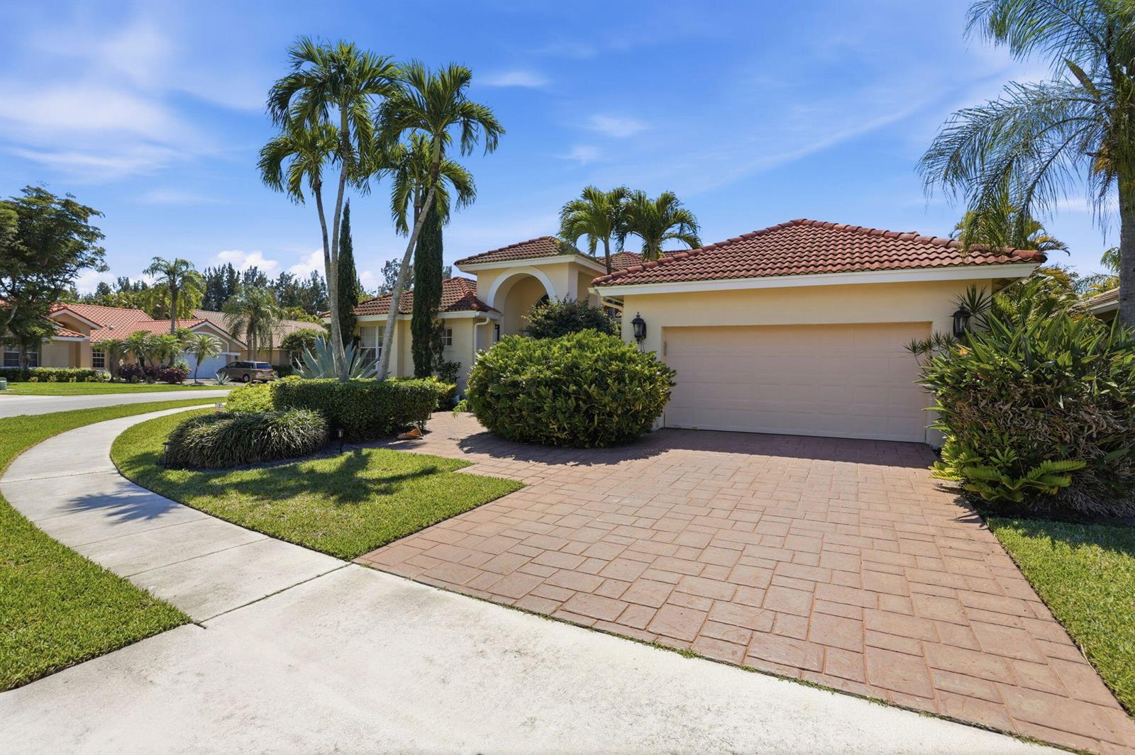 A single-story house with a tiled roof, a paved driveway, and palm trees in front — 7821 Dorchester Road, Boynton Beach FL 33472, BOYNTON BEACH, FL