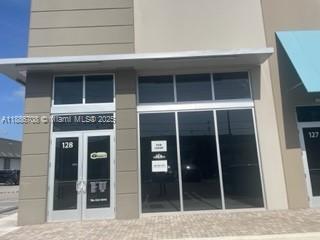 A commercial storefront with glass doors and windows under a metal awning — 10890 NW 17 TH ST # 128, Miami 00172, MIAMI, FL