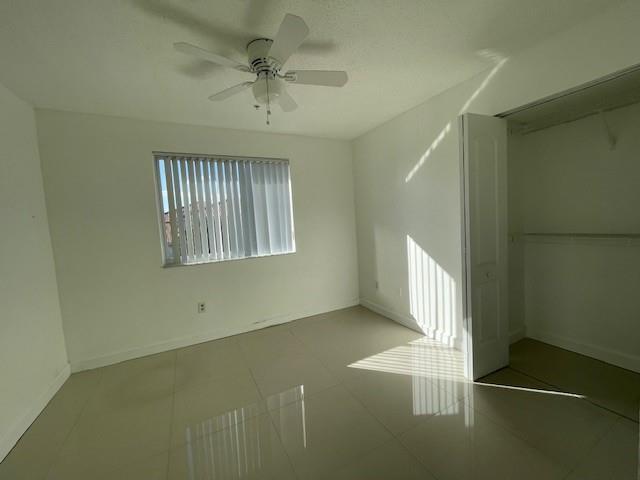 An empty bedroom features white walls, tile flooring, a ceiling fan, and a closet — 470 S Park Road # 302, Hollywood FL 33021, HOLLYWOOD, FL