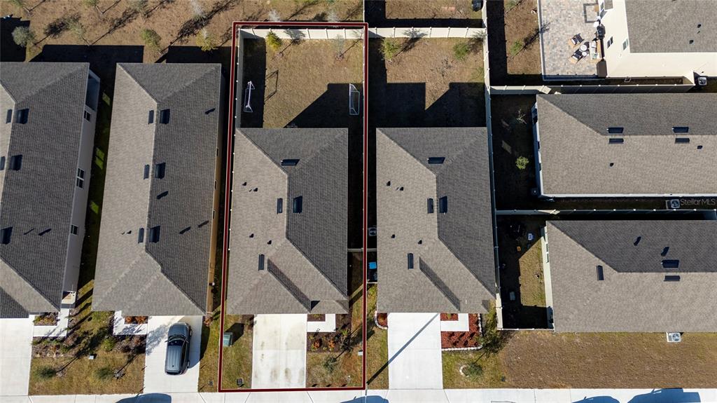 An aerial view shows a single-family home with a fenced backyard and driveway — 2815 MOULIN ROAD, DAVENPORT, FL