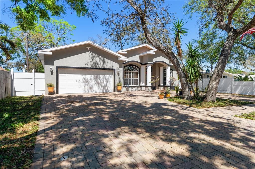 A single-story house with a paved driveway, a two-car garage, and a covered front entrance — 5001 44TH AVENUE N, ST PETERSBURG, FL