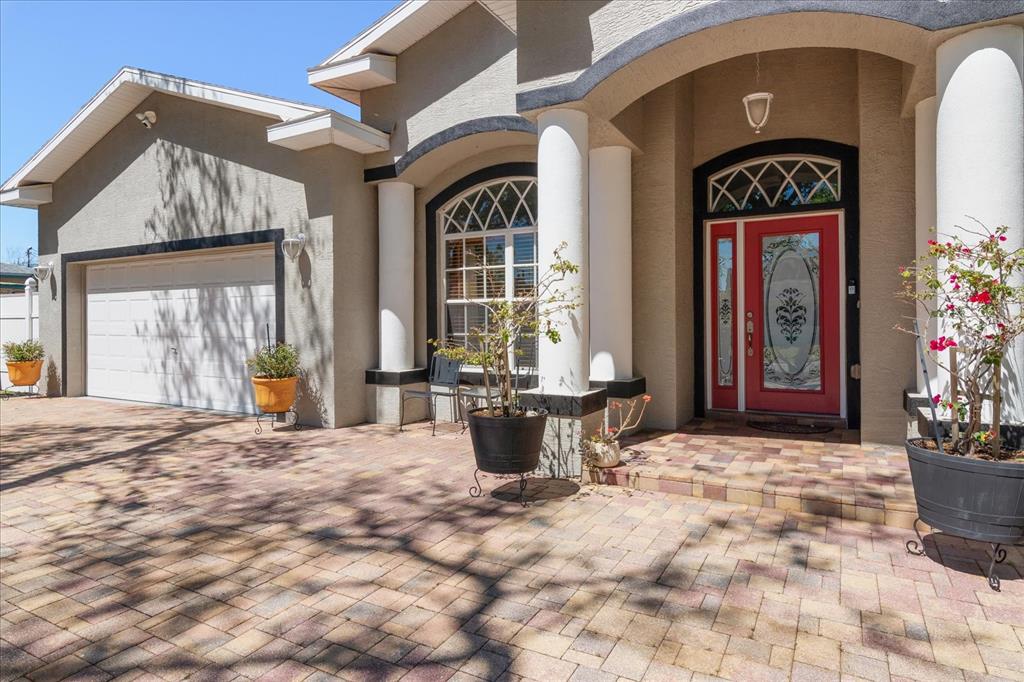 A paved driveway leads to a house with a red front door and white columns — 5001 44TH AVENUE N, ST PETERSBURG, FL