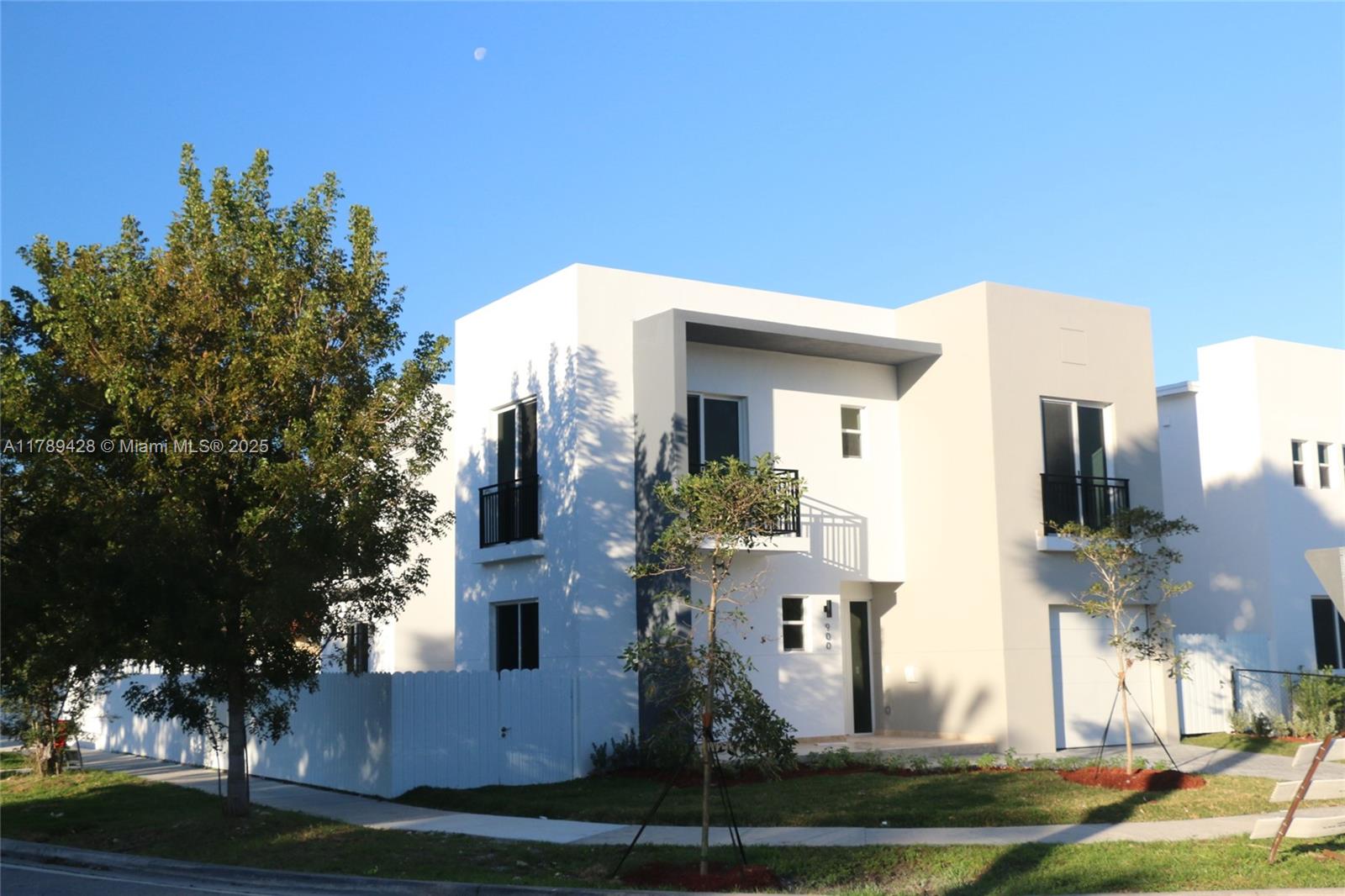 A modern two-story house with white and beige exterior walls and a small balcony — 900 SW 24th Rd, Miami FL 33129, MIAMI, FL