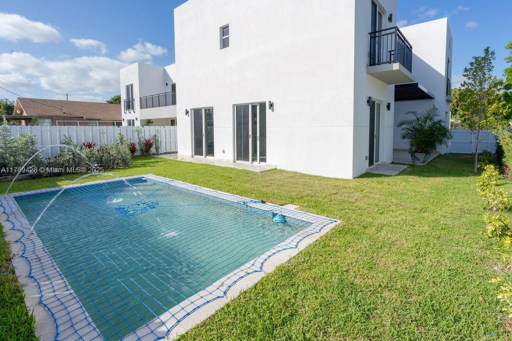 A white two-story house with a swimming pool covered by a safety net — 900 SW 24th Rd, Miami FL 33129, MIAMI, FL