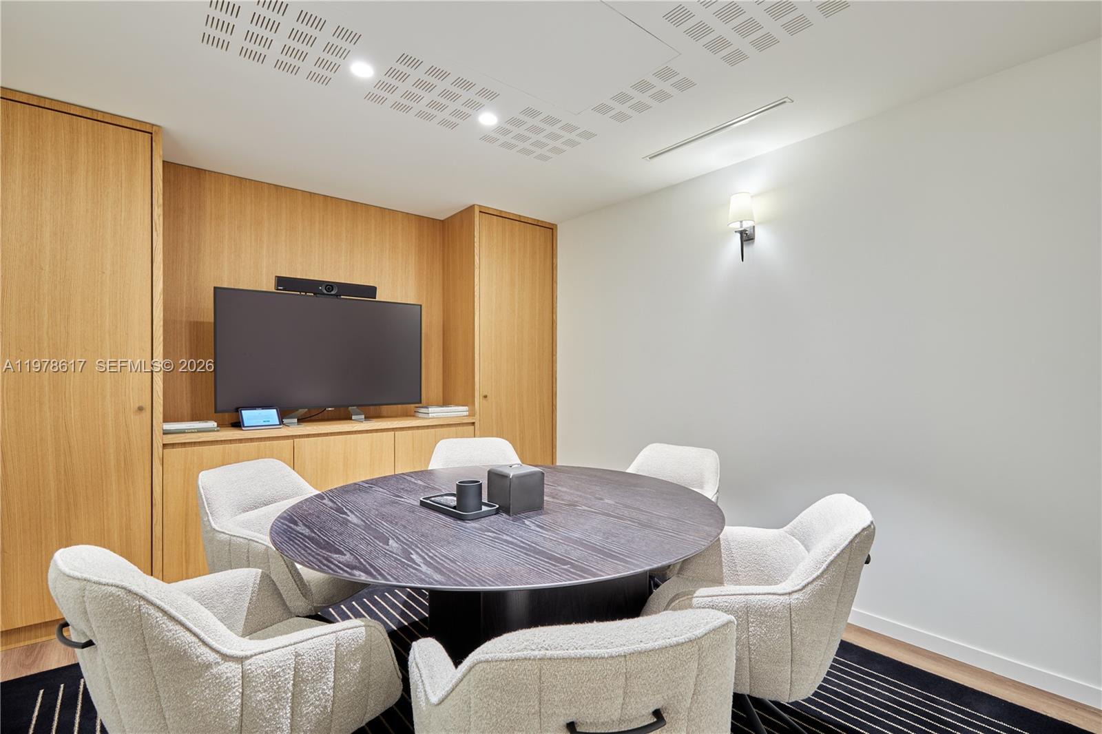 A conference room features a round dark wood table, six upholstered chairs, and wood cabinetry — 11 RUE ST DOMINIQUE, FR, FR