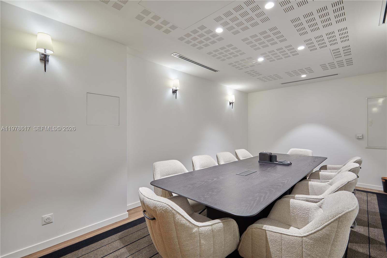 A modern conference room features a dark wood table, cream-colored chairs, and recessed ceiling lighting — 11 RUE ST DOMINIQUE, FR, FR