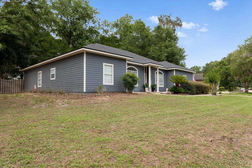 A single-story house with dark blue horizontal siding and a dark shingled roof — 5514 NW 78TH LANE, GAINESVILLE, FL