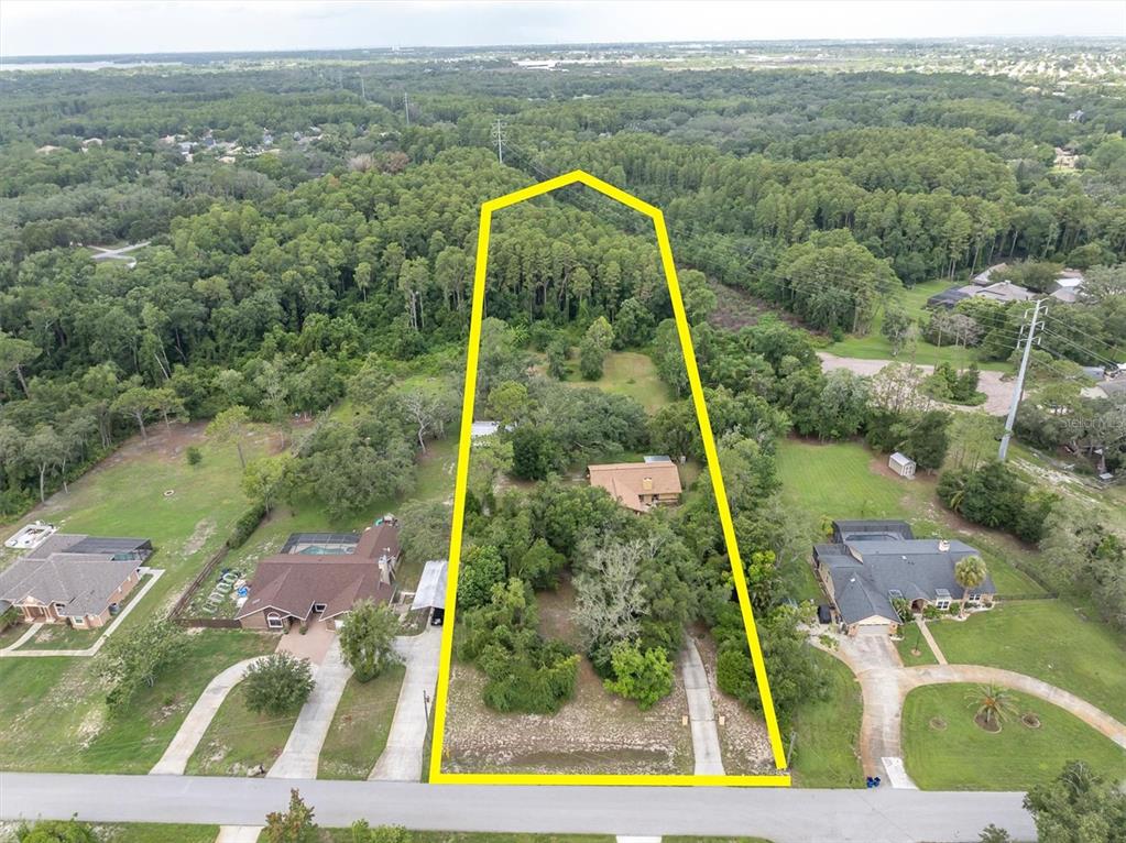 An aerial view shows a residential lot outlined in yellow with a house and trees — 6812 RIDGE TOP DRIVE, NEW PORT RICHEY, FL
