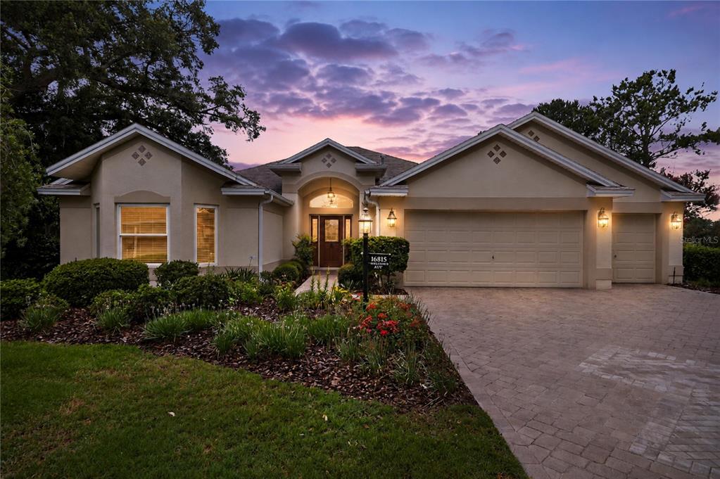 A view of a grassy yard with several pine trees overlooking a golf course — 16815 SE 85TH BELKNAP AVENUE, THE VILLAGES, FL