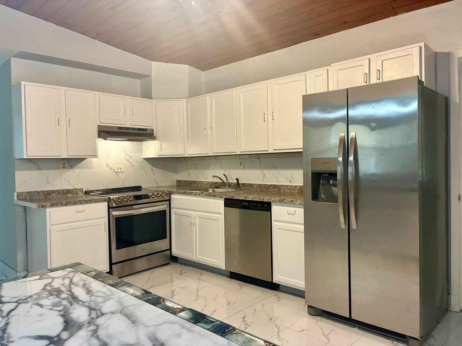 A kitchen with white cabinets, stainless steel appliances, granite countertops, and a wood-paneled ceiling — 3630 SW 46th Avenue, West Park FL 33023, WEST PARK, FL