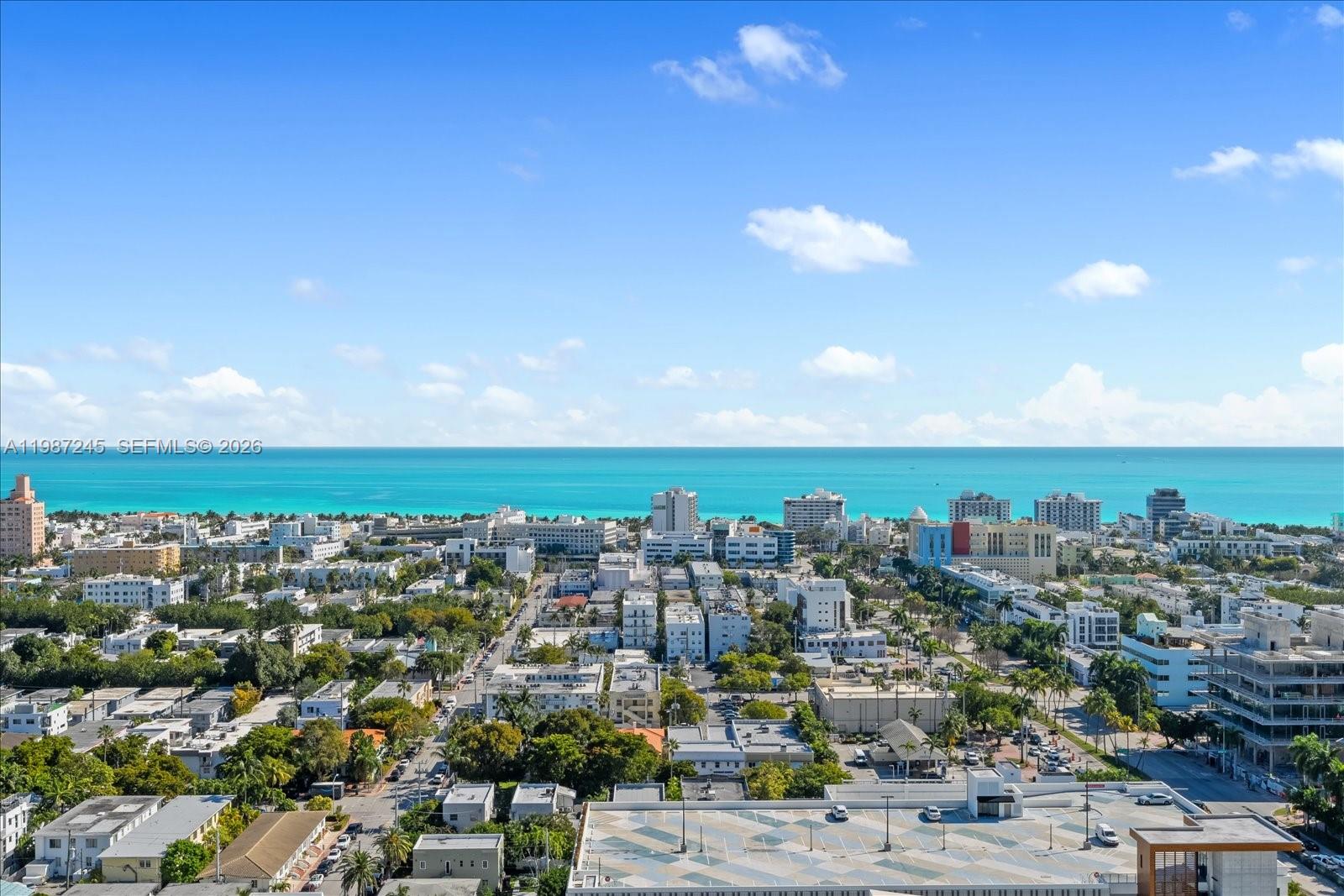An aerial view shows a coastal city skyline overlooking the turquoise ocean under a blue sky — 500 Alton Rd # 2402, Miami Beach FL 33139, MIAMI BEACH, FL