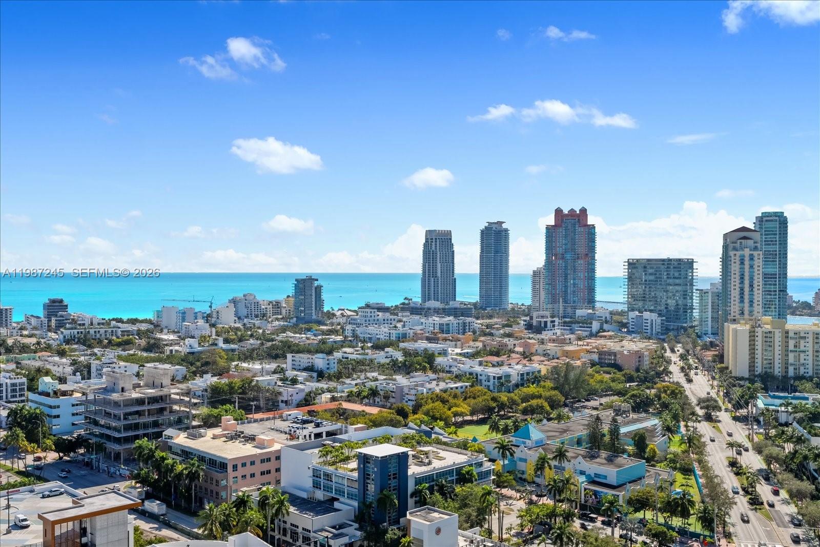 An elevated view shows a city skyline with high-rise buildings overlooking the ocean — 500 Alton Rd # 2402, Miami Beach FL 33139, MIAMI BEACH, FL