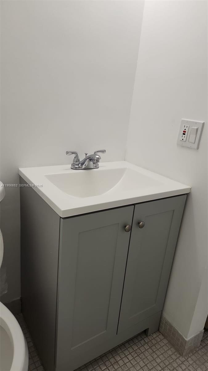 A bathroom vanity with a gray cabinet, white countertop, and chrome faucet — 4174 Inverrary Dr # 311, Lauderhill FL 33319, LAUDERHILL, FL