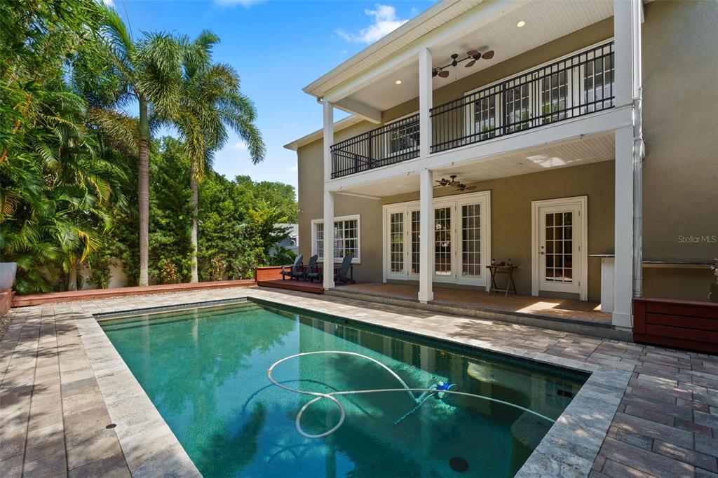A two-story house exterior features a swimming pool, a covered patio, and a second-floor balcony — 3317 W LEONA STREET, TAMPA, FL